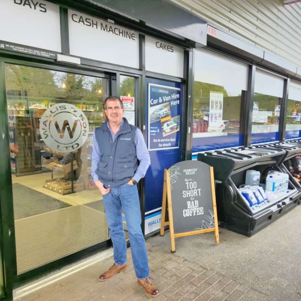 An image of Elliot Wallis standing outside his Wallis Pet Supplies store